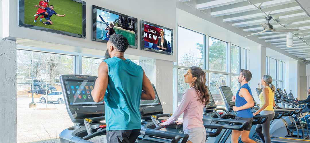 People being served in restaurant with sports on TV